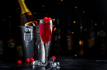 Moulin rouge cocktail drink with calvados, sparkling wine, lychee and raspberry peach puree and...