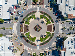 Aerial photo of a roundabout in a shopping center in Brentwood, California with palm trees,...