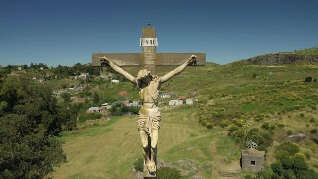 360 degre drone shot around a Christ statue on top of the mountain in the center of Tandil in Argentina