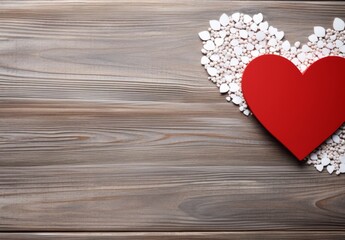 Red heart on white stones with copy space. Wooden background with copy space. Top view, flat lay. Valentine's Day.