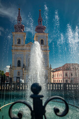 Old square with blue sky and fountain in sunny day in Kadan