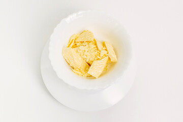There are pieces of cocoa butter in a white plate.