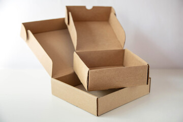Two open empty cardboard boxes are on a bright background.