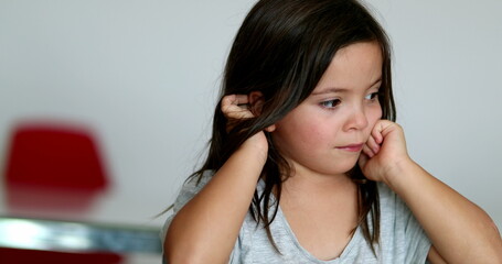 Fototapeta premium Tired little girl rubbing eyes with hands