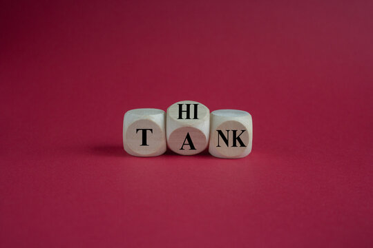 Think tank symbol. Turned a wooden cube and changes the word tank to think. Beautiful red background, copy space. Business and think tank concept.