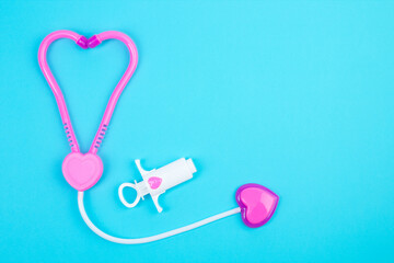 The concept of a pediatrician. Pediatrics. Toy medical devices on a blue background. Children play...