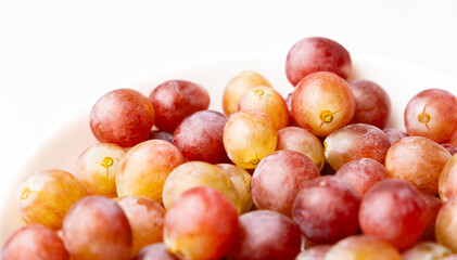 Naklejka na ściany i meble Pink sweet grapes close-up top view