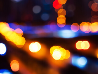 Blurry night scene, colourful light cones, traffic light / abstract background webdesign