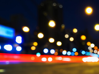 Blurry night scene, colourful light cones, traffic light / abstract background webdesign