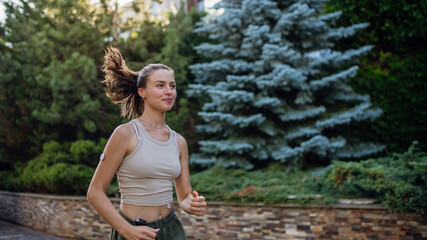 Beautiful diabetic woman running in the city. Young woman wearing insulin pump during exercising....