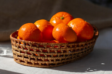 Delicious Tangerines apricots in a straw rustic  basket