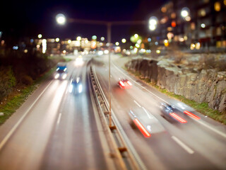 Long exposure tilt shift image of traffic passing on a highway.