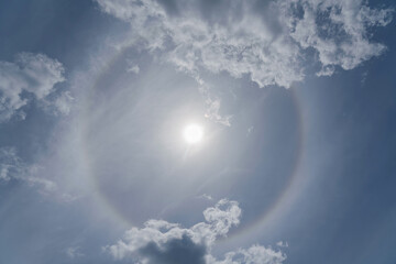 Solar, halo or sun dog, or parhelion  interesting atmospheric optical phenomenon in the blue sky