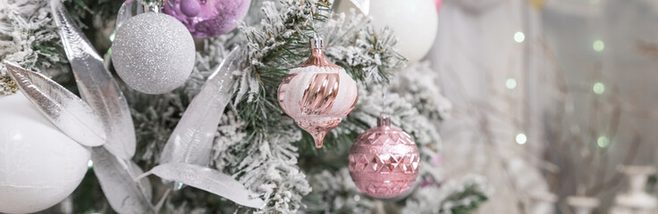 pink and white christmas tree decoration. Green and White Christmas tree with pink toys, new year winter gifts decor. Beautiful Christmas decoration. web banner - obrazy, fototapety, plakaty