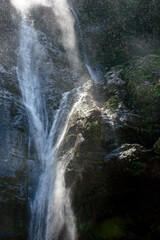 Water splashing against rocks in sunlit waterfall in Minas Gerais, Brazil