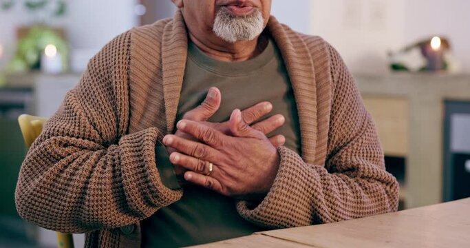 Hands on chest pain, heart attack or sick old man with asthma in home living room with an emergency. Trouble, medical crisis or elderly person with discomfort due to illness or breathing problem