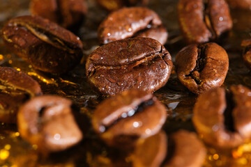 Roasted coffee beans in raindrops background golden veins.