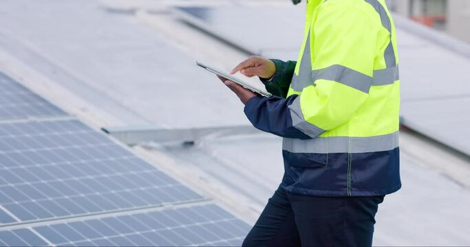 Typing tablet, construction worker and solar panels on a roof for futuristic and eco friendly energy. Digital, building and a contractor or person planning sustainable electricity on technology