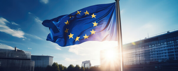 EU flag waving in front of modern building with sunshine