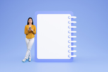 Smiling young chinese woman in casual typing on phone near big plan with copy space