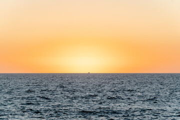 Fototapeta premium yacht at sunset sailing on the sea - puerto vallarta mexico