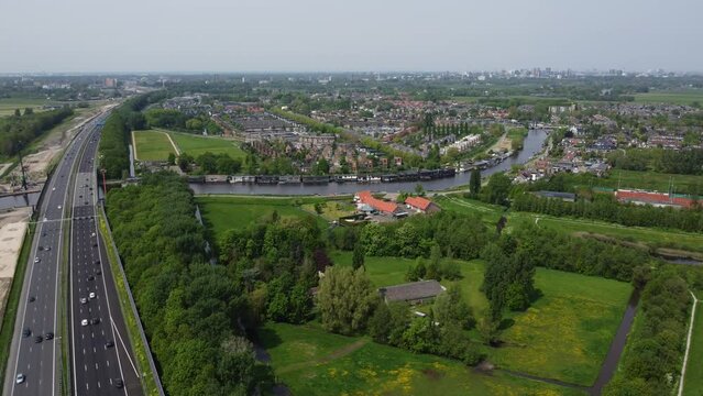 Steady dronefootage of highway next to Dutch town of Ouderkerk aan de Amstel