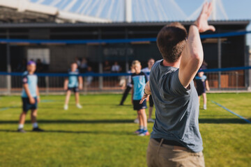 Volleyball game, junior teenage school team of kids play volleyball, players on the outdoor...