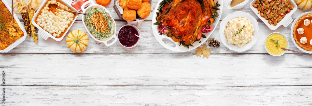 Canvas Prints Traditional Thanksgiving turkey dinner. Overhead view top border on a rustic white wood banner background. Turkey, mashed potatoes, stuffing, pumpkin pie and sides.