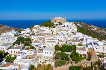The three windmills of Chora and iconic Monastery of Saint John the Theologian in chora of Patmos...