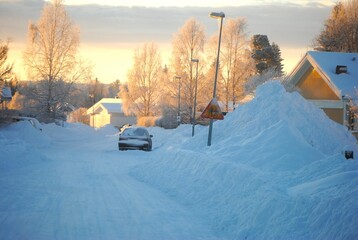 far away. Winter city in the north. Sweden Östersund. Car parked at snow-covered house.