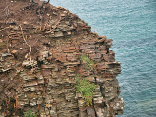 Heavily fractured rock strata in coastal cliffs on the Pembrokeshire Coast Path in Wales, UK...