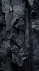 Fototapeta na wymiar Closeup of volcanic basalt with jagged edges, revealing deep, rich hues of charcoal and obsidian with jagged, uneven edges and a rough, gritty texture.