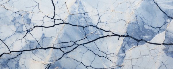 Closeup of mottled cracked marble with s in shades of blue, gray, and white. The cracks are thin and delicate, creating an intricate weblike pattern on the smooth surface of the marble.