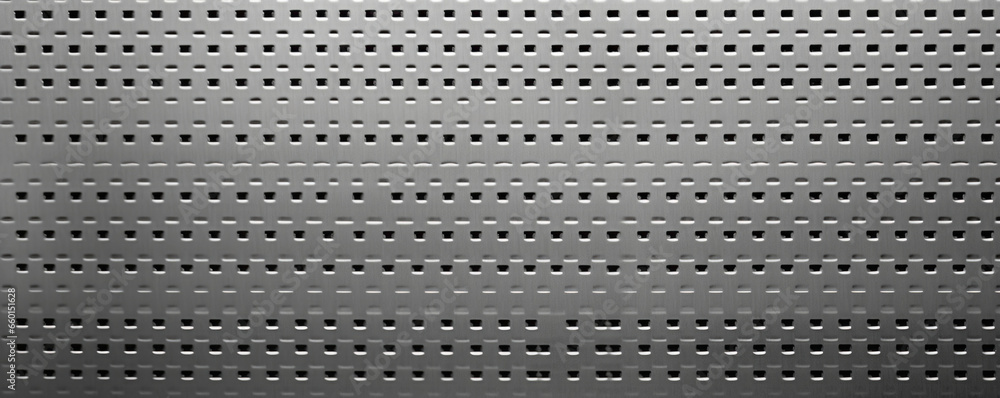 Poster texture of perforated steel, featuring a series of small holes evenly spaced throughout its surface.
