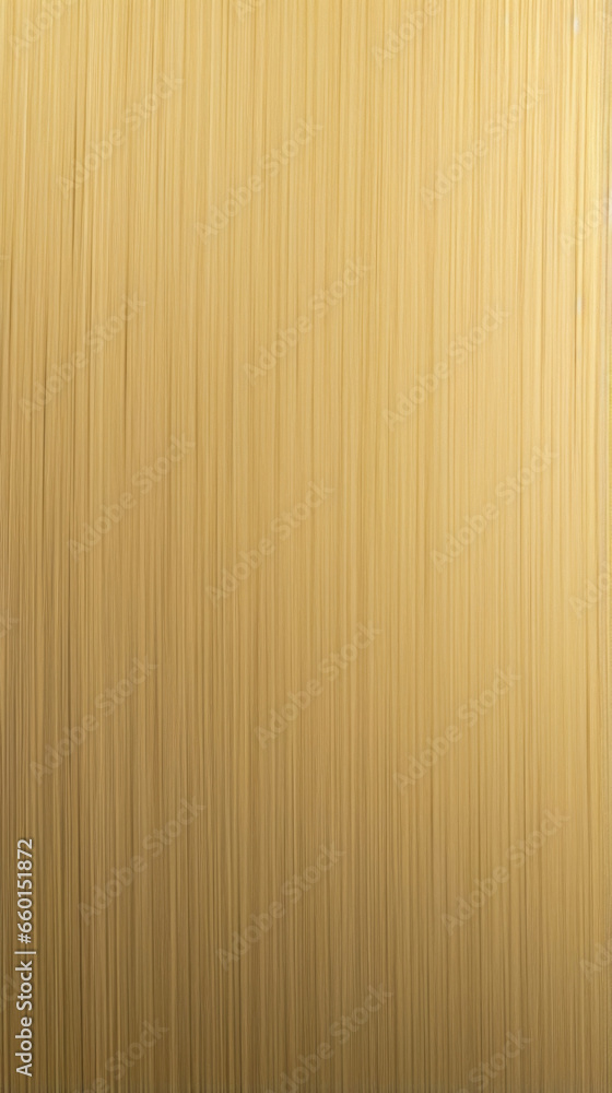 Poster closeup of a brushed brass texture, showcasing a linear pattern with subtle variations in color and 
