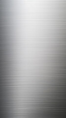 Closeup of a finely brushed polished stainless steel surface, revealing a subtle, linear texture.