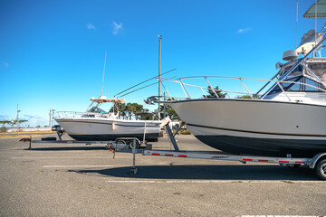 Fototapeta premium Large motor boats on car trailers parked at the pier.