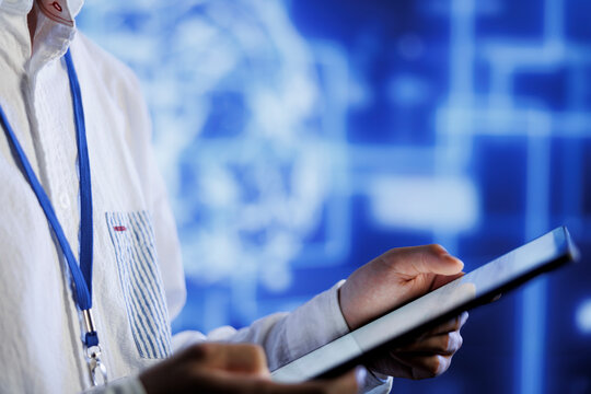 Computer scientist writes code on tablet to visualize artificial intelligence neural networks using augmented reality, close up. Server room professional runs AI script for information processing