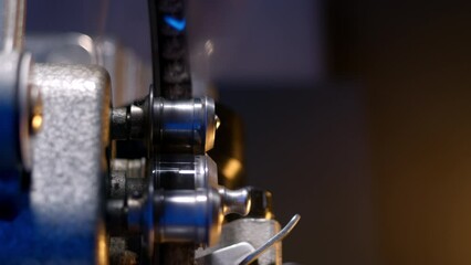 close-up view of reels of vintage film projector. projector comes to life, showing nostalgic movie in theater. opening scene introduces segment from a historical documentary.