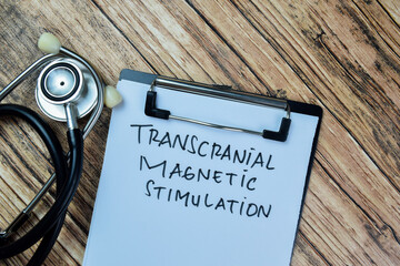 Concept of Transcranial Magnetic Stimulation write on paperwork isolated on Wooden Table. - Powered by Adobe