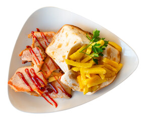 Fried Iberian pig served with potatoes and parsley closeup. Isolated over white background