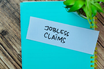 Concept of Jobless Claims write on sticky notes isolated on Wooden Table.