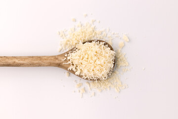 grated parmesan in wooden spoon isolated on white
