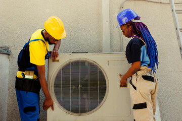 Capable electrician and precise serviceman opening up old malfunctioning condenser to replace it...