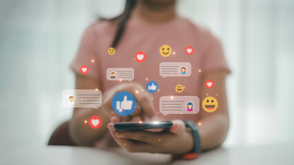 Social media interactions on mobile phones, concept with notification icons of like, message, email, comment above smartphone screen, person hands holding device, internet digital marketing