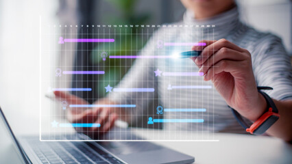 Analyst working with computer in management system to make report with KPI and metrics connected to...