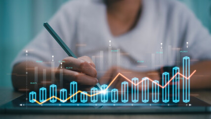 Data analysis concepts. Businesswomen calculate financial data for long-term investments. Businesswomen analyze the profitability of working companies with digital augmented reality graphics,