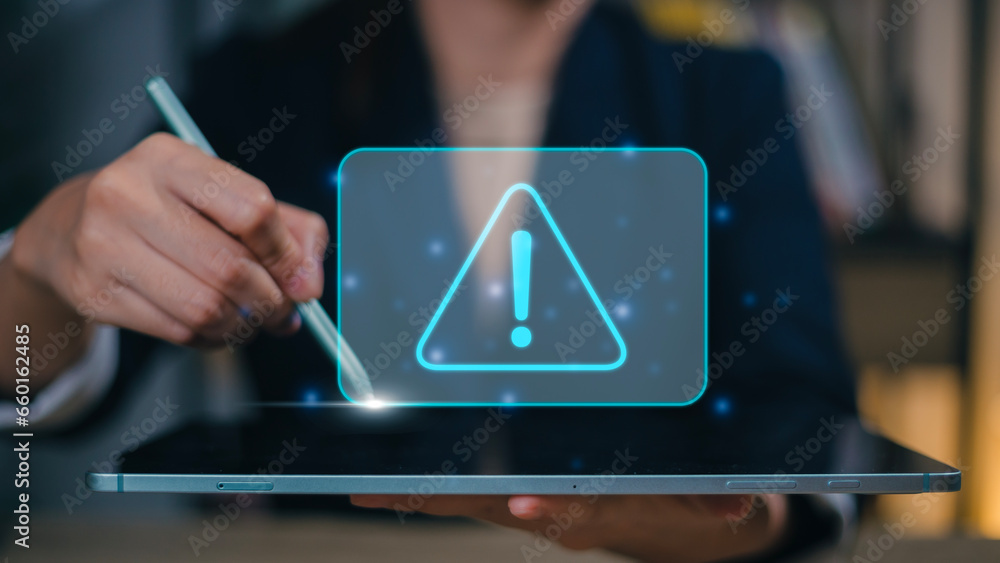 Aufkleber businesswomen using computer laptop or tablet with triangle caution warning sign for notification er
