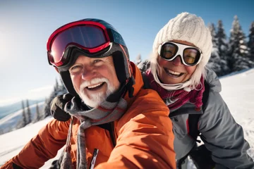 Fotobehang Candid capture of a joyful senior couple showing vitality while travel by snowmobile in the mountains on winter holidays. Active lifestyle in retirement © samael334