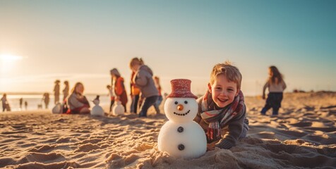 boy showing the snowman he built on the beach for Christmas Day - obrazy, fototapety, plakaty